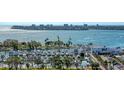 Picturesque aerial view of a marina featuring an array of boats docked amidst waterfront buildings and lush greenery at 1350 Main St # 1410, Sarasota, FL 34236