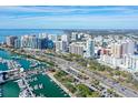 Wide aerial view captures a bustling city with high-rise buildings and a marina filled with boats along the waterfront at 1350 Main St # 1410, Sarasota, FL 34236