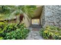 Inviting entryway with stone accents and lush landscaping at 1423 Kimlira Ln, Sarasota, FL 34231