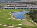 Aerial view showcasing a villa next to a golf course and lake at 17505 Opal Sand Dr # 108, Venice, FL 34293