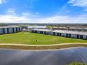 Aerial view of community with villas near golf course and lake at 17505 Opal Sand Dr # 108, Venice, FL 34293