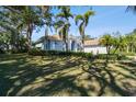 House exterior showcasing a manicured lawn and palm trees at 1854 Amberwynd W Cir, Palmetto, FL 34221