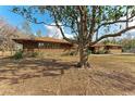 Brick house with a large tree in the yard at 2119 Zipperer Rd, Bradenton, FL 34212