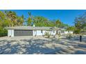 Modern home exterior featuring a dark garage door and gravel landscaping at 2133 Oriole Dr, Sarasota, FL 34239