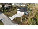 Aerial view of a single-Gathering home with a long driveway and green lawn at 2323 Zuyder Ter, North Port, FL 34286