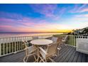 Relaxing waterfront deck with seating for four, perfect for enjoying sunsets at 30 Tidy Island Blvd, Bradenton, FL 34210