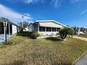 Single-wide mobile home with awning and large yard at 308 Danube Cir, Bradenton, FL 34207