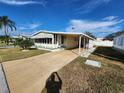 Front view of manufactured home with driveway and landscaping at 308 Danube Cir, Bradenton, FL 34207