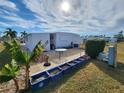 Mobile home patio with table, planters, and tropical plants at 308 Danube Cir, Bradenton, FL 34207