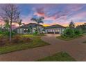 Luxury home with tile roof, stone accents, and a 3-car garage at 3123 Founders Club Dr, Sarasota, FL 34240