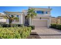 Beautiful two-story home with a two car garage and lush landscaping at 3598 Fair Oaks Ln, Longboat Key, FL 34228