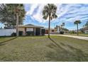 House with palm trees, a white fence, and a spacious yard at 372 Tihami Rd, Venice, FL 34293