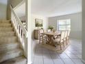 Bright dining room featuring tile floors, a rustic wood table and a window for natural light at 3822 Ironwood Ct, Sarasota, FL 34243