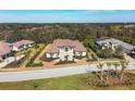 Luxury home with tile roof, expansive driveway, and lush landscaping at 3927 Founders Club Dr, Sarasota, FL 34240