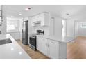 Bright, modern kitchen featuring white cabinets, stainless steel appliances, and an island at 3952 Coleridge Pl, Sarasota, FL 34241