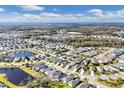 Aerial view of a large residential community with houses, roads, and a lake at 4121 Deep Creek Ter, Parrish, FL 34219