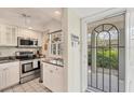 Well-equipped kitchen featuring stainless steel appliances and granite counters at 4350 Chatham Dr # E106, Longboat Key, FL 34228