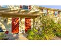 Front view of two-story townhouses with red doors and lush landscaping at 4850 51St W St # 9106, Bradenton, FL 34210