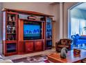 Elegant home theater setup with large wood cabinet at 5250 Manorwood Dr # 4A, Sarasota, FL 34235