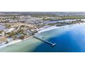 Wide aerial shot showcasing the coastline and condos, complemented by a pier and beachfront amenities at 559 Bahia Beach Blvd, Ruskin, FL 33570