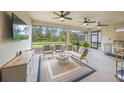 Outdoor space with seating area, ceiling fans, and a built-in grill at 5892 Semolino St, Nokomis, FL 34275