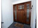 Elegant wood front door with glass panels and sidelights at 603 Saint Andrews Dr, Sarasota, FL 34243