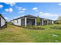 Screened patio with grassy backyard and landscaping at 6240 Fish Eagle Ct, Nokomis, FL 34275