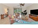 Spacious living room featuring comfortable seating and a grand piano at 6814 Willowshire Way, Bradenton, FL 34212