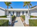 Front entry with walkway, landscaping, and white columns at 6851 Country Lakes Cir, Sarasota, FL 34243