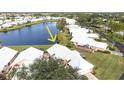 Aerial view showcasing the community's lakefront location and villa-style homes at 713 Harrington Lake N Dr # 18, Venice, FL 34293