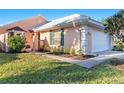 Front view of a light peach house with a white garage door and walkway at 713 Harrington Lake N Dr # 18, Venice, FL 34293