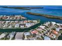 Aerial view of waterfront home with private dock and canal access at 721 Old Compass Rd, Longboat Key, FL 34228