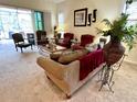 Spacious living room featuring comfortable seating and a large window at 7619 Teal Trace, Bradenton, FL 34203