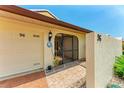 Covered entryway with a charming screen door and brick walkway at 96 Drifting Sands Dr, Venice, FL 34293