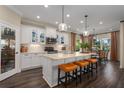 Spacious kitchen featuring white cabinets, island, and hardwood floors at 10624 Falling Leaf Ct, Parrish, FL 34219