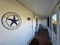 Front porch with seating and starfish decor at 100 The Esplanade N # 6, Venice, FL 34285