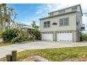 Two-story home with double garage and landscaped yard at 115 Burns Rd, Terra Ceia, FL 34250