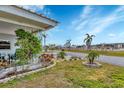 Landscaped yard with palm trees and paved pathway at 1204 43Rd E Ave, Ellenton, FL 34222