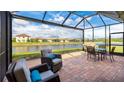 Relaxing screened patio with water view and comfortable seating at 12563 Felice Dr, Venice, FL 34293