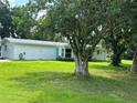 Side view of the house with mature landscaping at 1703 Center Rd, Terra Ceia, FL 34250