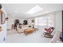 Bright living room featuring a skylight and comfortable furnishings at 1716 Forest Rd, Venice, FL 34293