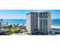 Beachfront condo building exterior showcasing ocean views and balconies at 2295 Gulf Of Mexico Dr # 115S, Longboat Key, FL 34228