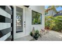 Modern entrance with a glass-paneled front door and meticulous landscaping at 2434 Wood St, Sarasota, FL 34237