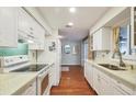 Modern kitchen featuring white cabinets, quartz countertops, and stainless steel appliances at 2503 Bispham Rd, Sarasota, FL 34231