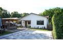 Contemporary home with a spacious paved driveway and outdoor seating area at 2606 19Th St, Sarasota, FL 34234