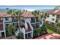 Condo building exterior showcasing waterfront views and tropical landscaping at 3460 Wild Oak Bay Blvd # 145, Bradenton, FL 34210