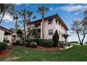 Ground-level condo unit with balcony and tropical landscaping at 3460 Wild Oak Bay Blvd # 145, Bradenton, FL 34210