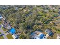 A spacious lot with mature trees, outlined in white, offering privacy and potential for building at 3864 Gocio Rd, Sarasota, FL 34235