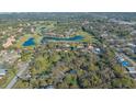 An aerial view of a tree-filled lot with possible building options near a golf course and ponds at 3864 Gocio Rd, Sarasota, FL 34235