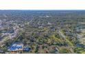 Expansive land, defined by a white line, surrounded by dense trees and established homes at 3864 Gocio Rd, Sarasota, FL 34235